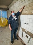 Hoffmann zeigt den Wasserstand, indem er seine Hand an die Wand hält. Die Linie verläuft rund einen Kopf über ihm.